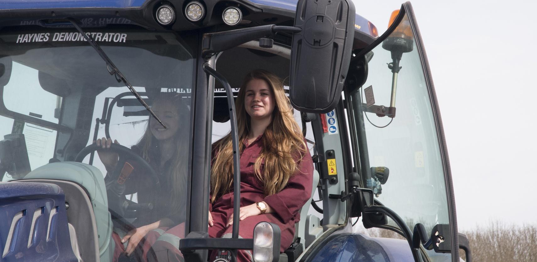 Two female students in a tractor