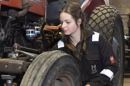 girl working on tractor