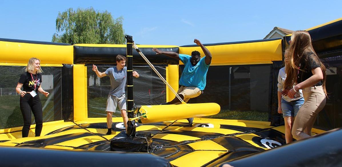 Students on an inflatable at freshers fair