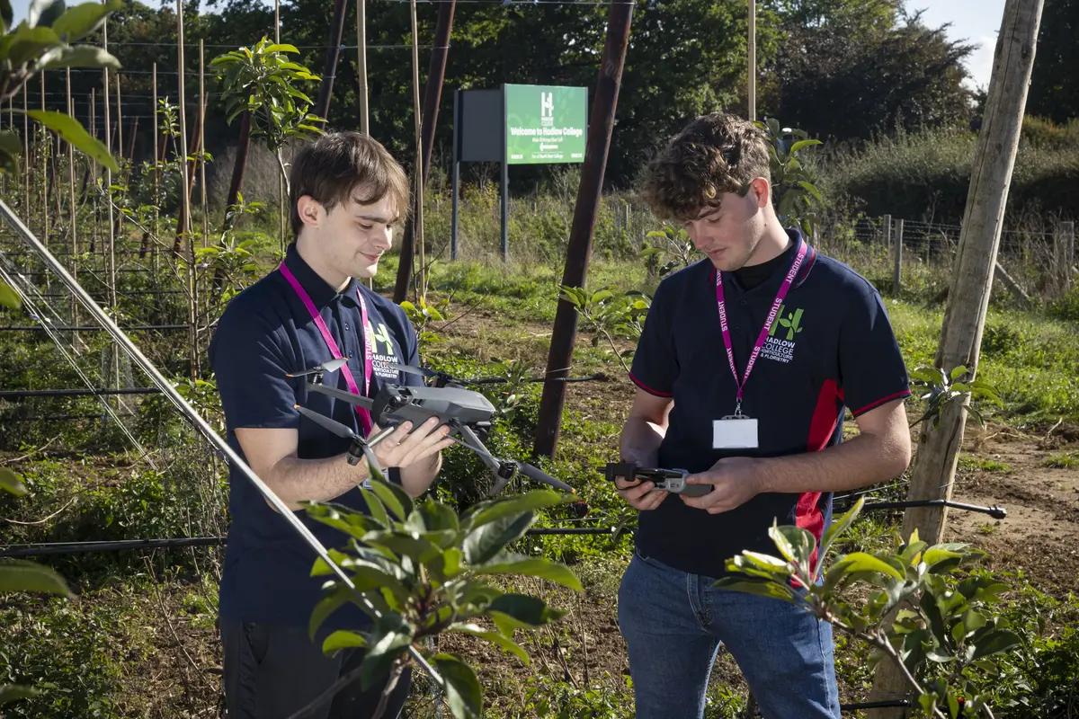 HAD Horticulture students with drone in orchard