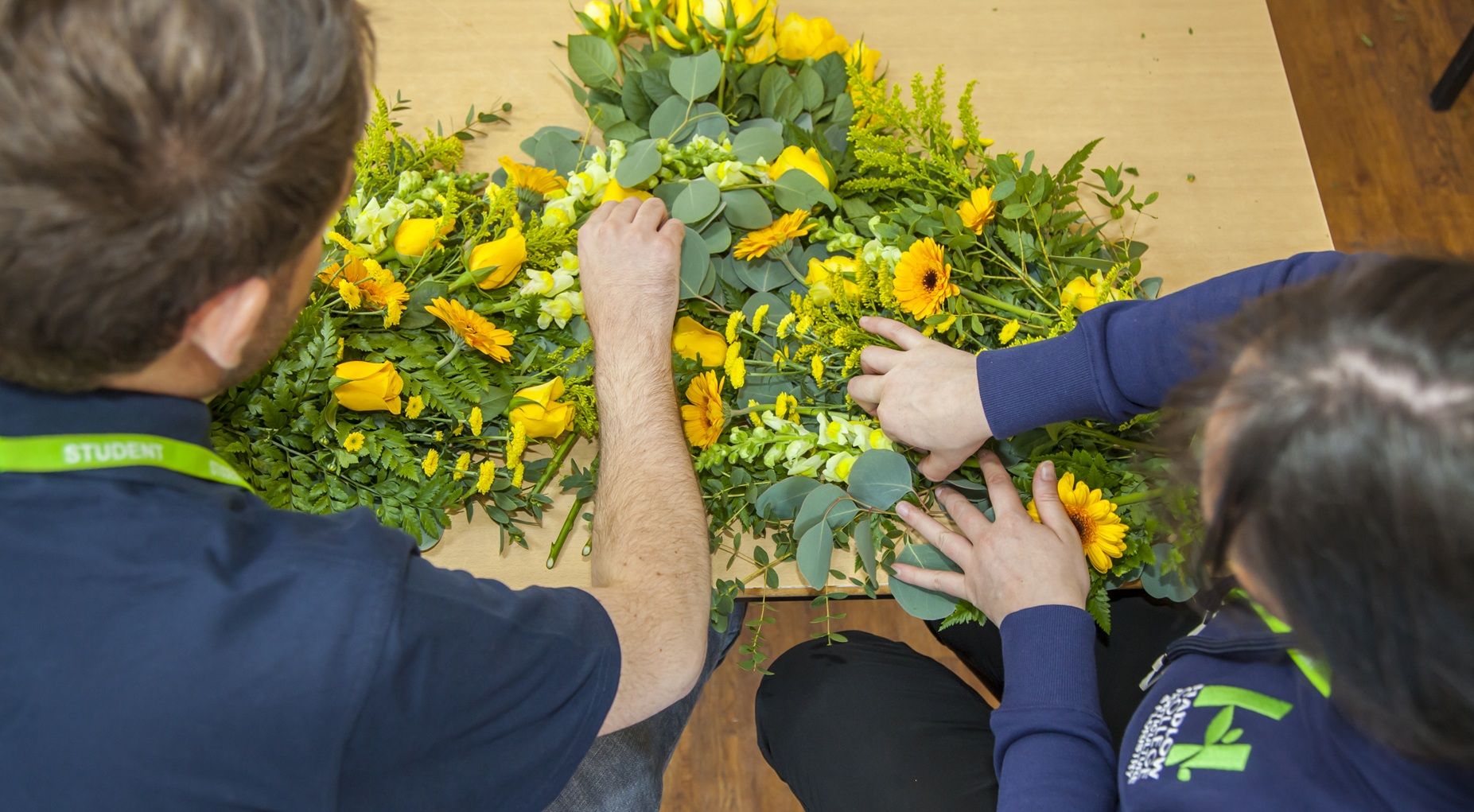 Hands arranging flowers