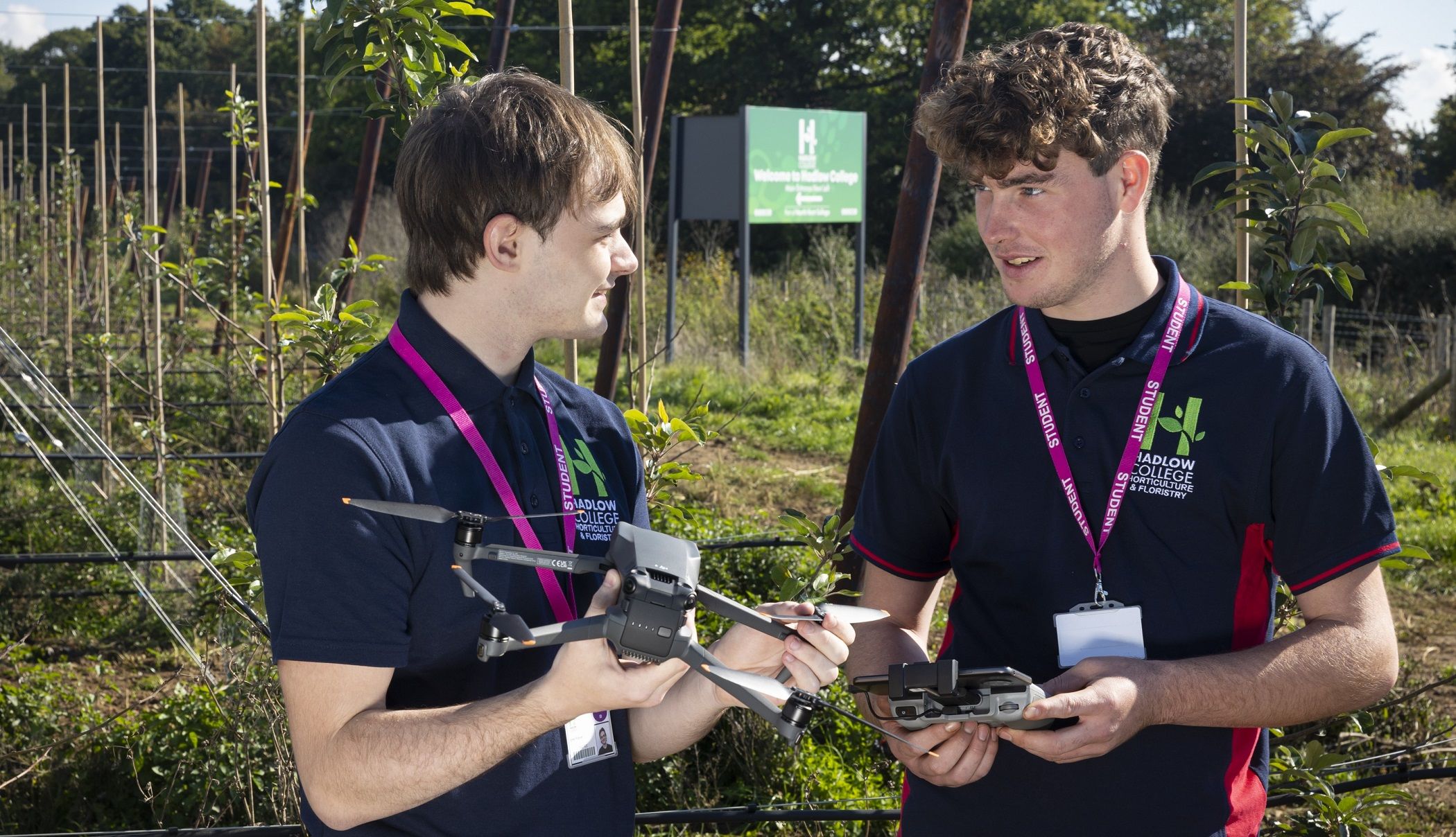 HAD Horticulture students with drone in orchard looking at eachother crop resize