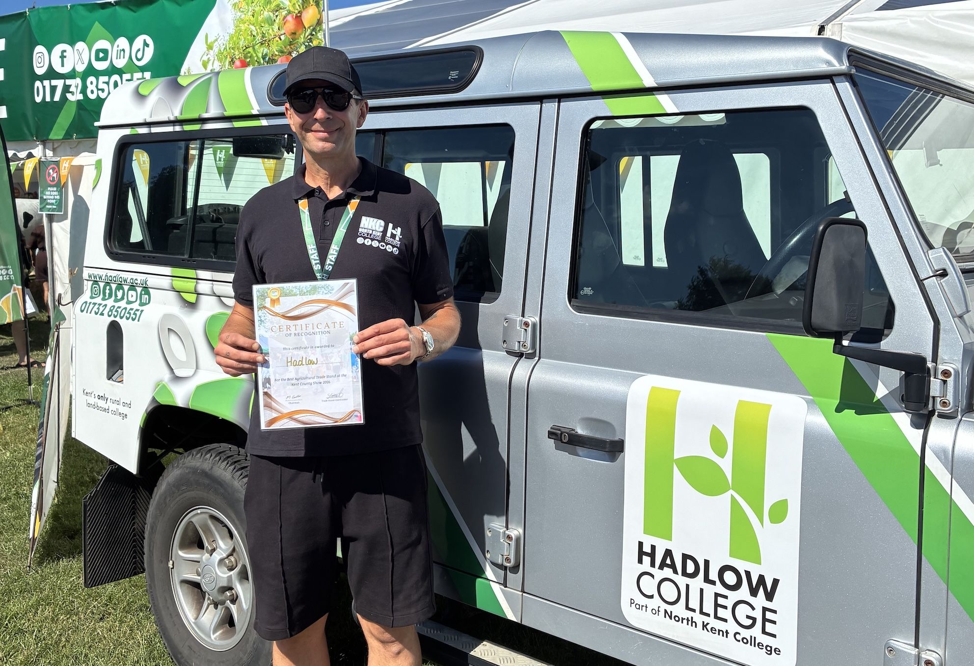 KCS award win pictured next to branded van and stand holding certificate