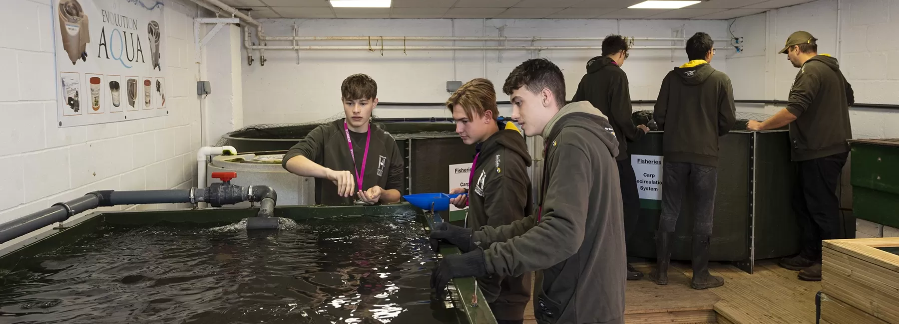 students feeding catfish