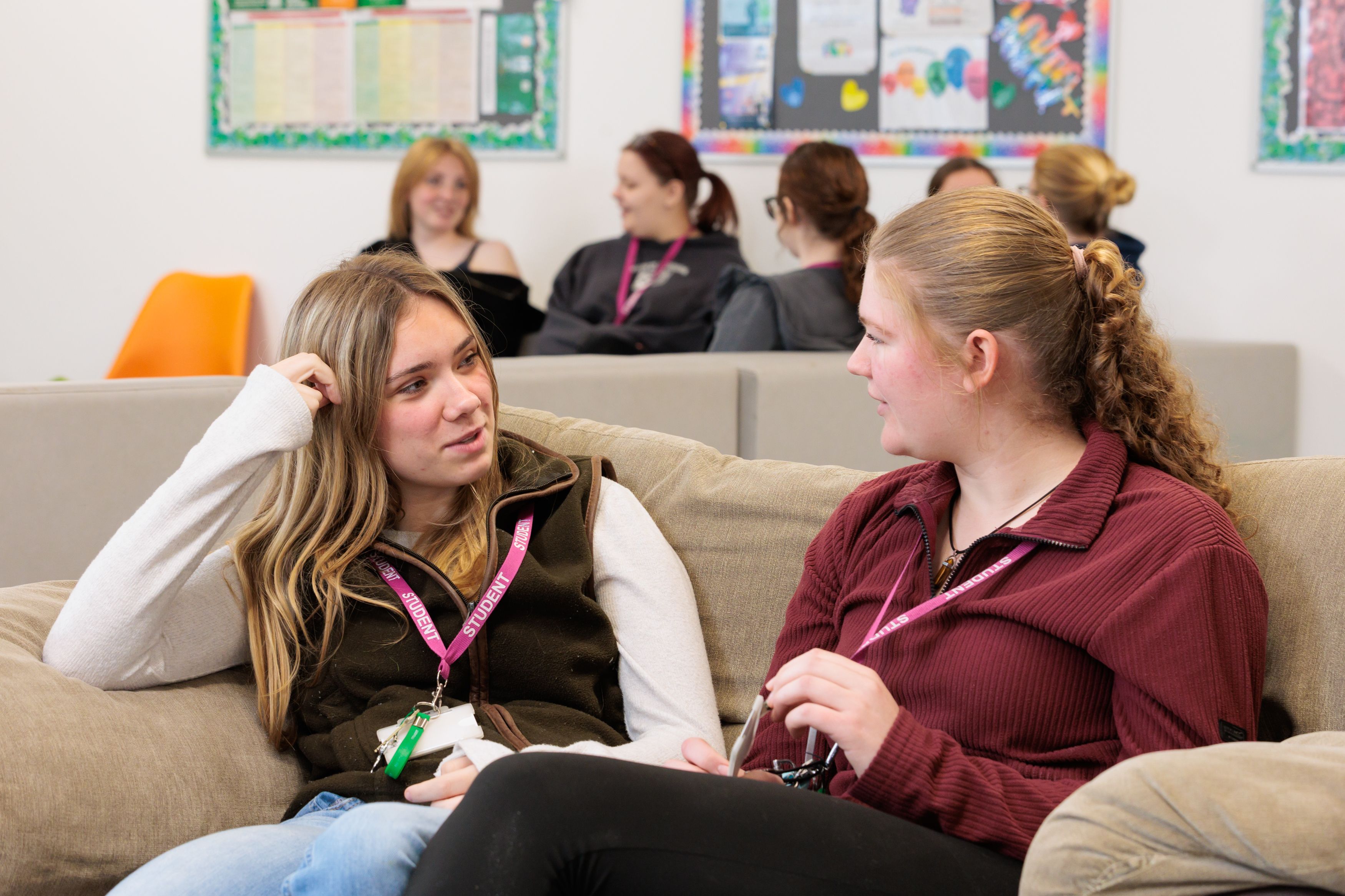 hadlow-college-landscape-residential-hub-two-students-talking-on-sofa