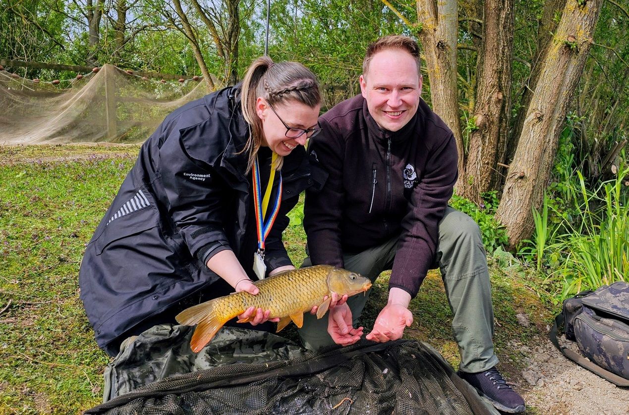 Man and woman holding fish