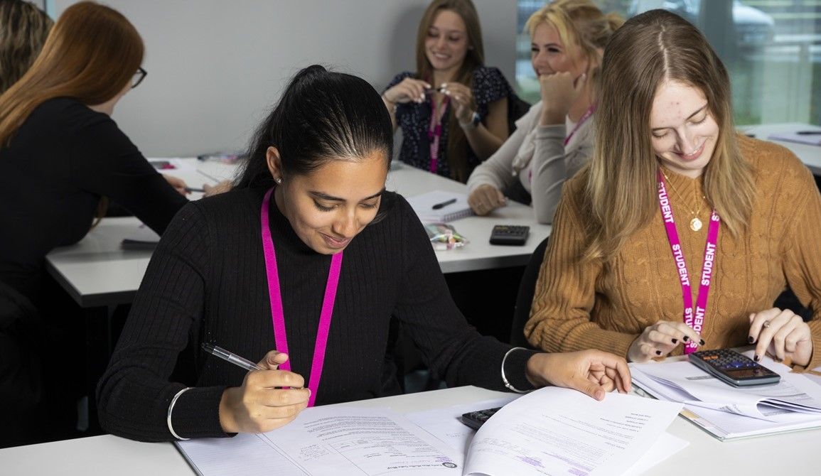 Two girls sitting at desk studying