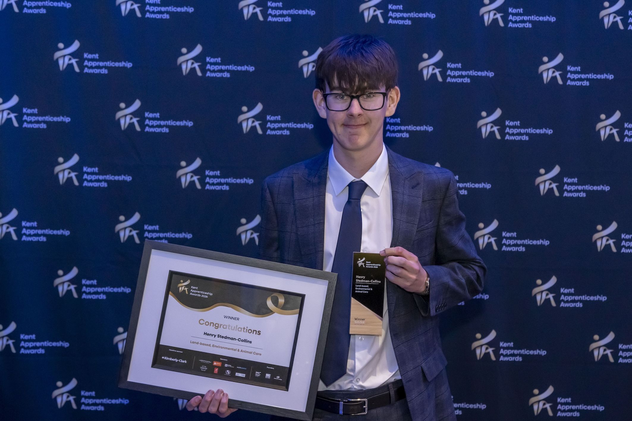Student holding award certificate