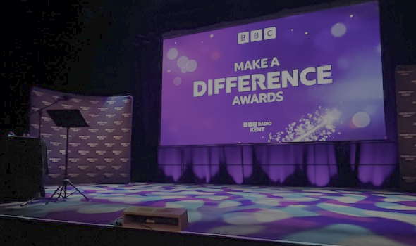 Stage with large screen showing BBC Make a Difference Awards signage